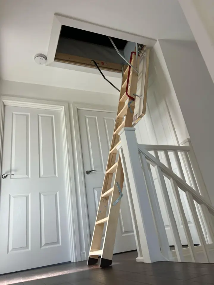 White wooden loft ladder in a new-build home